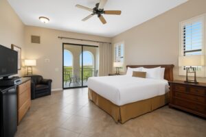 Hotel room with king bed, furniture and sliding door to balcony