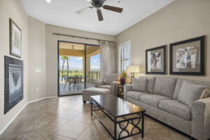 Hotel living area with furniture and sliding glass door to balcony