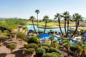 View of the golf resort with swimming pool, golf field and trees