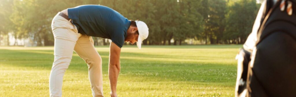 Young male doing golf warm-up exercises before the game