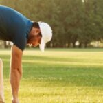 Young male doing golf warm-up exercises before the game
