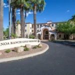Affordable hotels near Tucson, Canoa Ranch Golf Resort entrance with palm trees and sign
