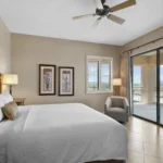Hotel suite bedroom at Canoa Ranch with king bed, private patio, and Santa Rita Mountain views — ideal for extended stays in AZ.