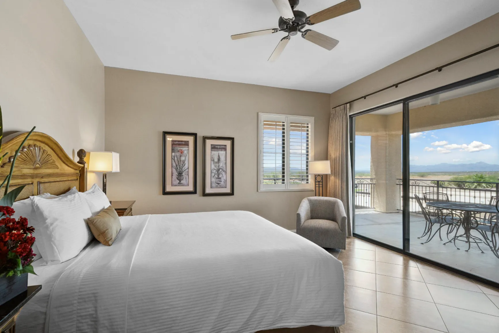 Hotel suite bedroom at Canoa Ranch with king bed, private patio, and Santa Rita Mountain views — ideal for extended stays in AZ.